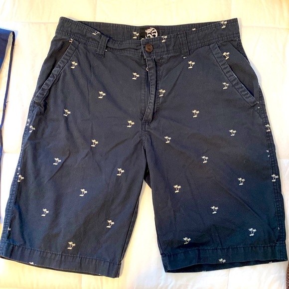 Blue shorts with white palm trees. - Picture 1 of 2